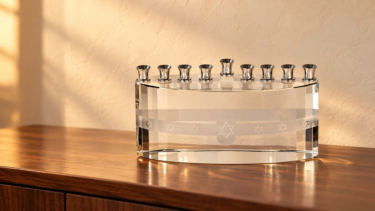 Clear crystal Chanukah menorah on a warm walnut console in an ivory room