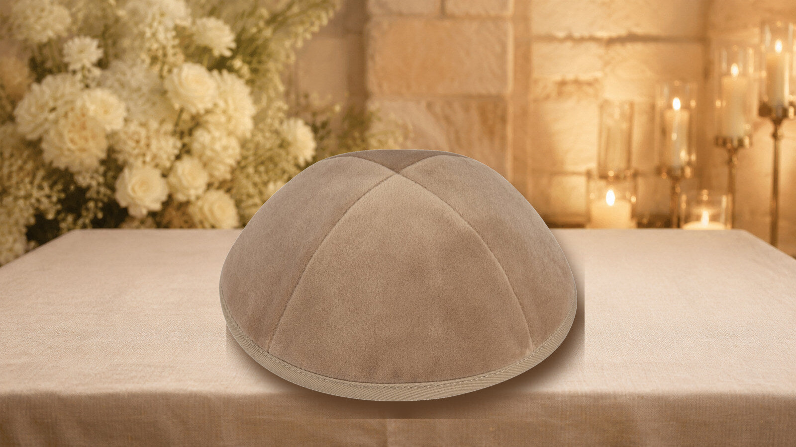 Camel velvet kippah displayed on an ivory linen table at a warmly lit simcha