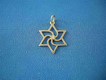 Open gold Star of David pendant with swirling pinwheel center and small diamond, on blue fabric