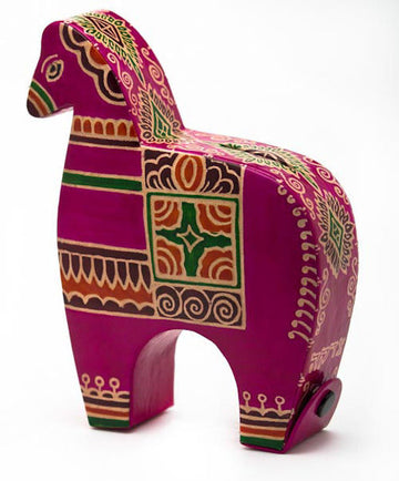 Pink tooled leather horse tzedakah box with green and gold folk patterns