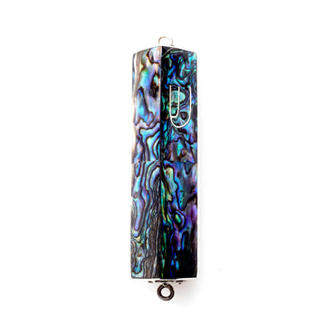 Triangular abalone mezuzah case in iridescent blue and green with a sterling silver Shin and end loops