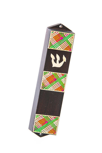 Slim dark wood mezuzah with pink, green and orange plaid straw panels and a pale straw Shin