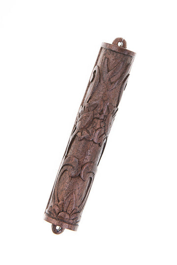 Dark ebony mezuzah case with flowing carved floral relief and end loops, angled view
