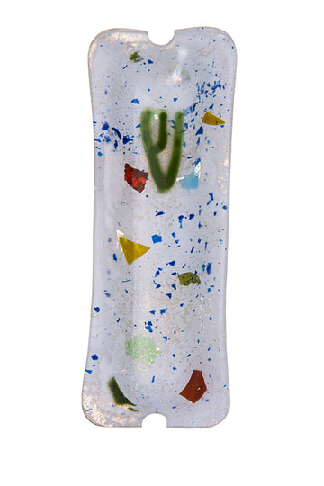 White abstract glass mezuzah with blue speckles, red, yellow and green glass fragments and a green Shin