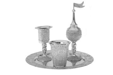 Silver plated havdalah set with the cup, spice box and candle holder standing together