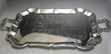 Silver plated tray with scalloped rim, engraved floral center and ornate cast handles