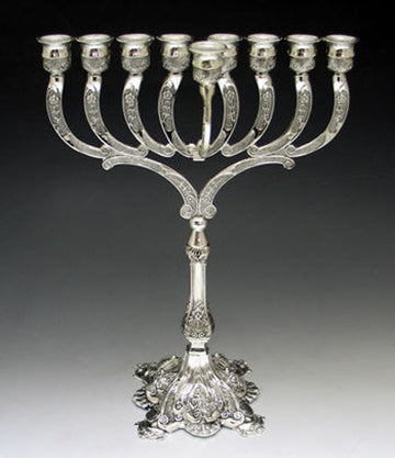 Silver plated menorah with engraved curved arms, a raised center shamash and an ornate footed base