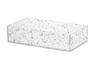 Rectangular lucite napkin holder with silver flakes suspended in the clear panels