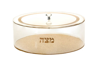 Lidded round Lucite matzah holder with a solid gold-tone base, gold lid ring and Hebrew Matzah lettering