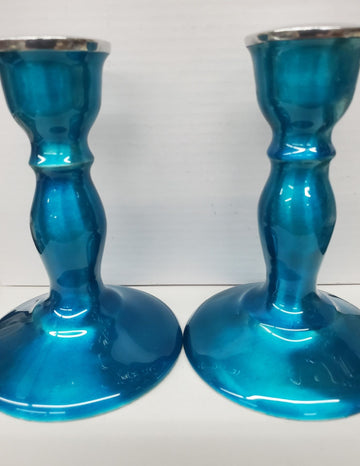 Two glossy teal metal candlesticks with turned stems and wide round bases