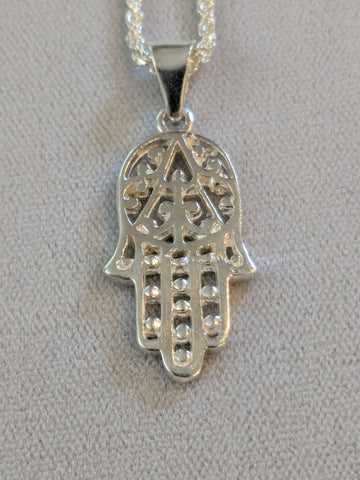 Sterling silver openwork Hamsa with beaded fingers on a rope chain, gray background