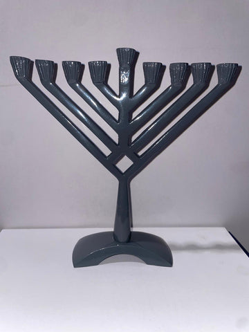 Grey metal Chanukah menorah folded into a V with nine candle holders in a rising line
