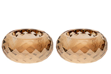 Two faceted amber crystal tea light holders side by side, low rounded shape with cut facets