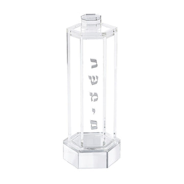 Clear hexagonal acrylic besamim holder with silver Hebrew lettering, shown empty