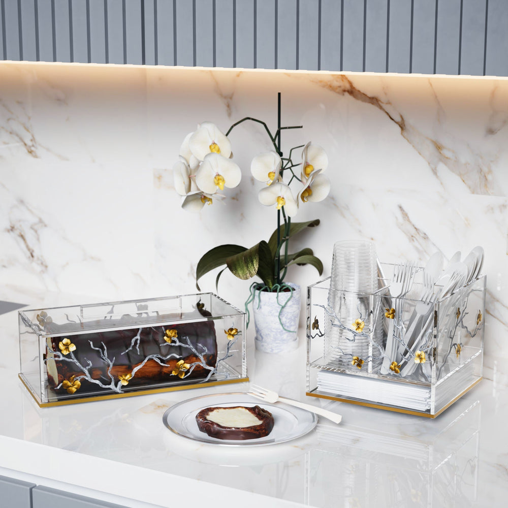Golden Branch cake holder and serving accessories on a marble counter.