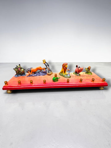 Collector’s Edition Lion King “Circle of Life” Menorah, red and pink base lined with Lion King character figures and…