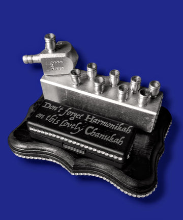 The Harmonikiah harmonica menorah with a rhinestone-trimmed case and metal candle cups