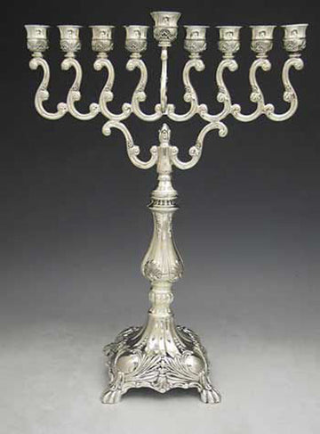Silver plated menorah with S-scroll arms, ornate cups and a footed base with shell decoration