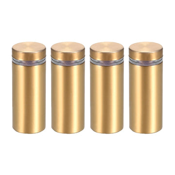 Set of four gold floating wall-mount screws standing upright on a white background
