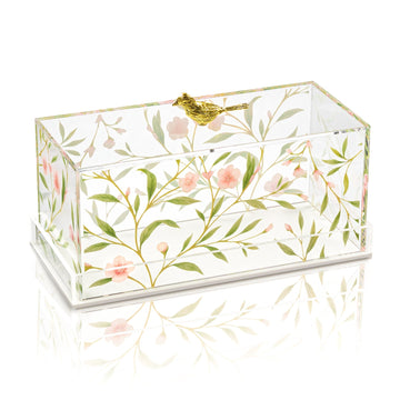 Clear acrylic cake dome with painted pink floral vine and gold bird clasp on a white background