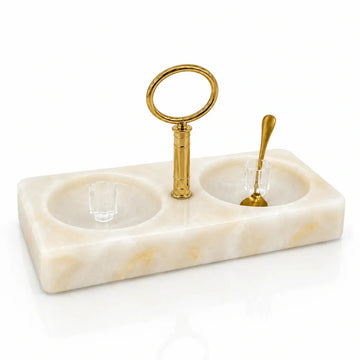 Marbled resin honey-and-salt dish with a gold ring carrying handle and two Lucite covers