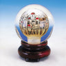Crystal globe reverse-painted with Jerusalem buildings and red domes on a dark carved wood stand