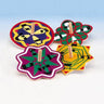 Four flat painted wooden spinning dreidels in red, purple, green and yellow star and round shapes