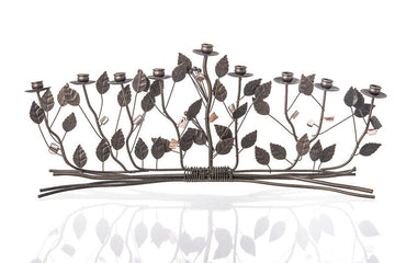 Wide bronze menorah of leafy branches bound at the base, with pearl accents and nine cups