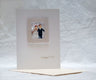 White card with a tiny 3-D bride and groom inside a patterned photo frame and gold Mazel Tov text