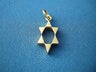 Elongated open 14K yellow gold Star of David pendant with jump ring on blue fabric