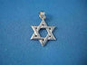 Interwoven 14K white gold Star of David pendant with polished finish on blue fabric