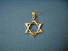 Contemporary Stargate 14K gold Star of David pendant with rounded open center on blue fabric