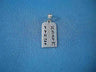 White gold Ten Commandments tablets pendant with pierced Hebrew letters, laid on blue cloth
