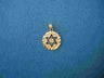 Round yellow gold medallion with a cut out Star of David and scalloped diamond cut rim, on blue