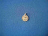 Tiny round gold medallion with a Chai and textured rim on a jump ring, on blue fabric
