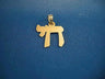 Flat angular yellow gold Chai pendant with a polished face and small bale, on blue