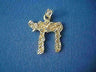 Tall rough-hewn yellow gold Chai covered in faceted diamond cut texture, on blue cloth