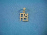 Gold charm of stacked Hebrew letters spelling Ahava with a bale, on blue fabric