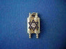 Gold Torah scroll pendant with a dark blue enamel Star of David framing Hebrew lettering