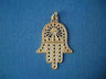 Large gold hamsa with a pierced sunburst palm and dotted rows down each finger, on blue