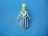 Open-outline gold hamsa with a pale blue heart-shaped topaz at the palm, on blue fabric