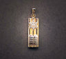 Gold columned mezuzah charm with a silver-toned Star of David above twin tablets, on grey