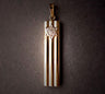 Tall mezuzah charm of three gold columns with a pale Star of David at top, on dark grey