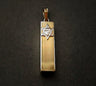 Polished rectangular gold mezuzah charm with a pale Star of David near the top, on black