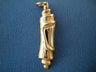 Sculpted yellow gold scroll-shaped mezuzah charm with folds forming a Shin, on blue