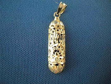 14K yellow gold filigree mezuzah charm with openwork pattern, shown on blue fabric