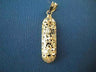 14K yellow gold filigree mezuzah charm with openwork pattern, shown on blue fabric