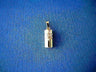 Small smooth gold cylinder mezuzah charm with a white gold Star of David, on blue fabric