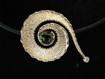 Spiral 14k gold shofar pendant with green tourmaline center and diamond at the tip on a black band