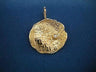 Round hammered-texture gold pendant with a single small diamond, hanging from a slim bale